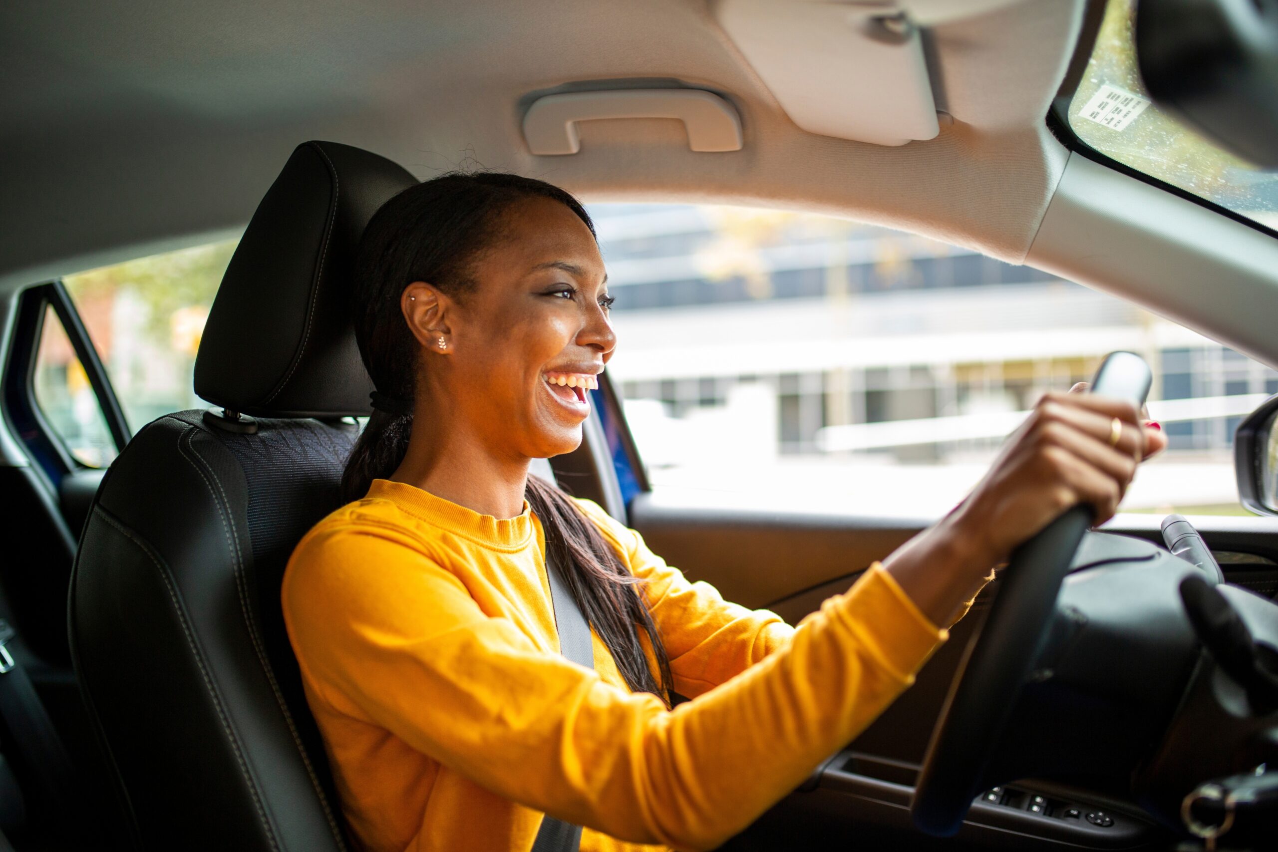 A joyful adult woman driving