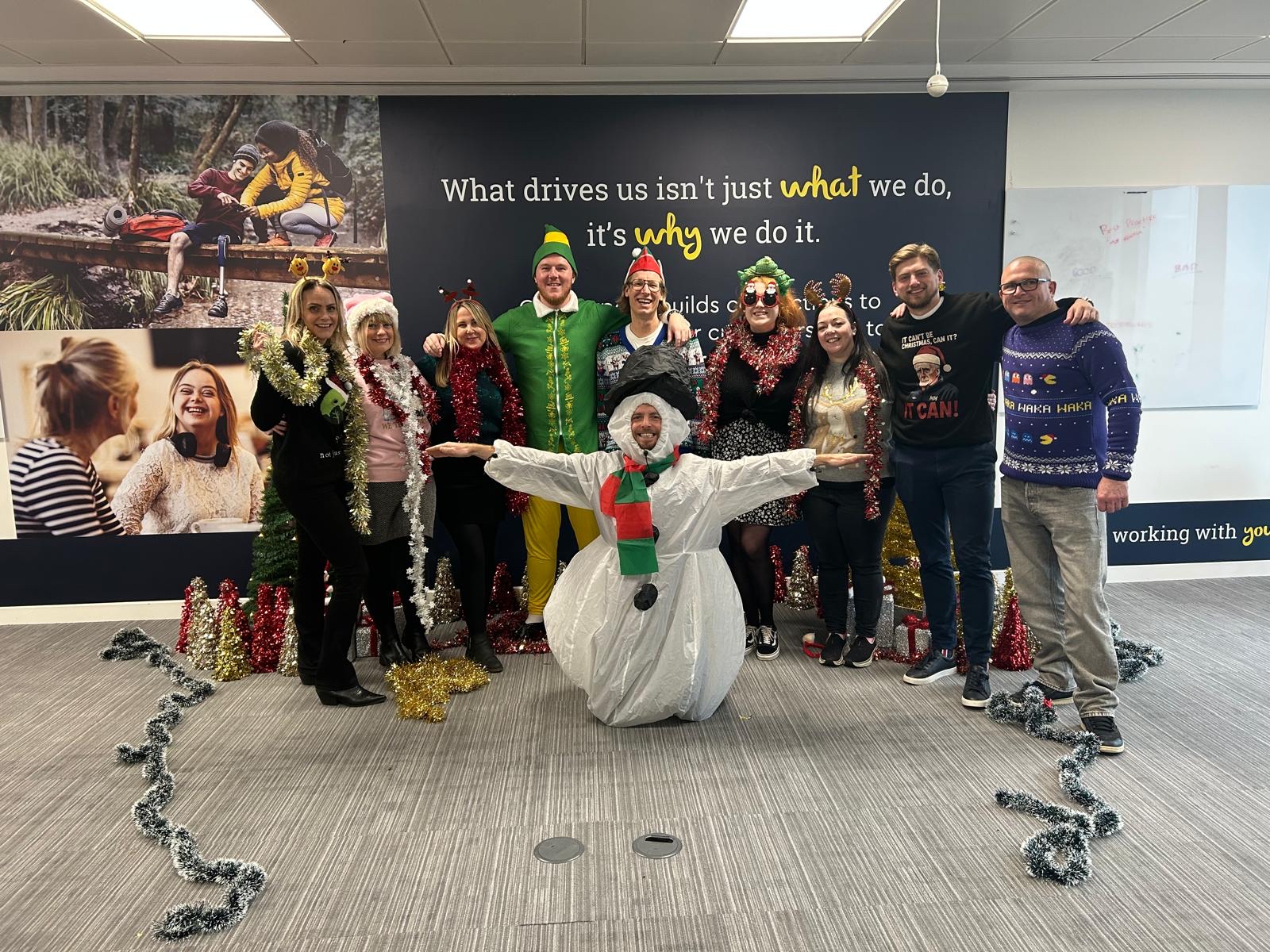 Group of Hodge employees in Christmas outfits