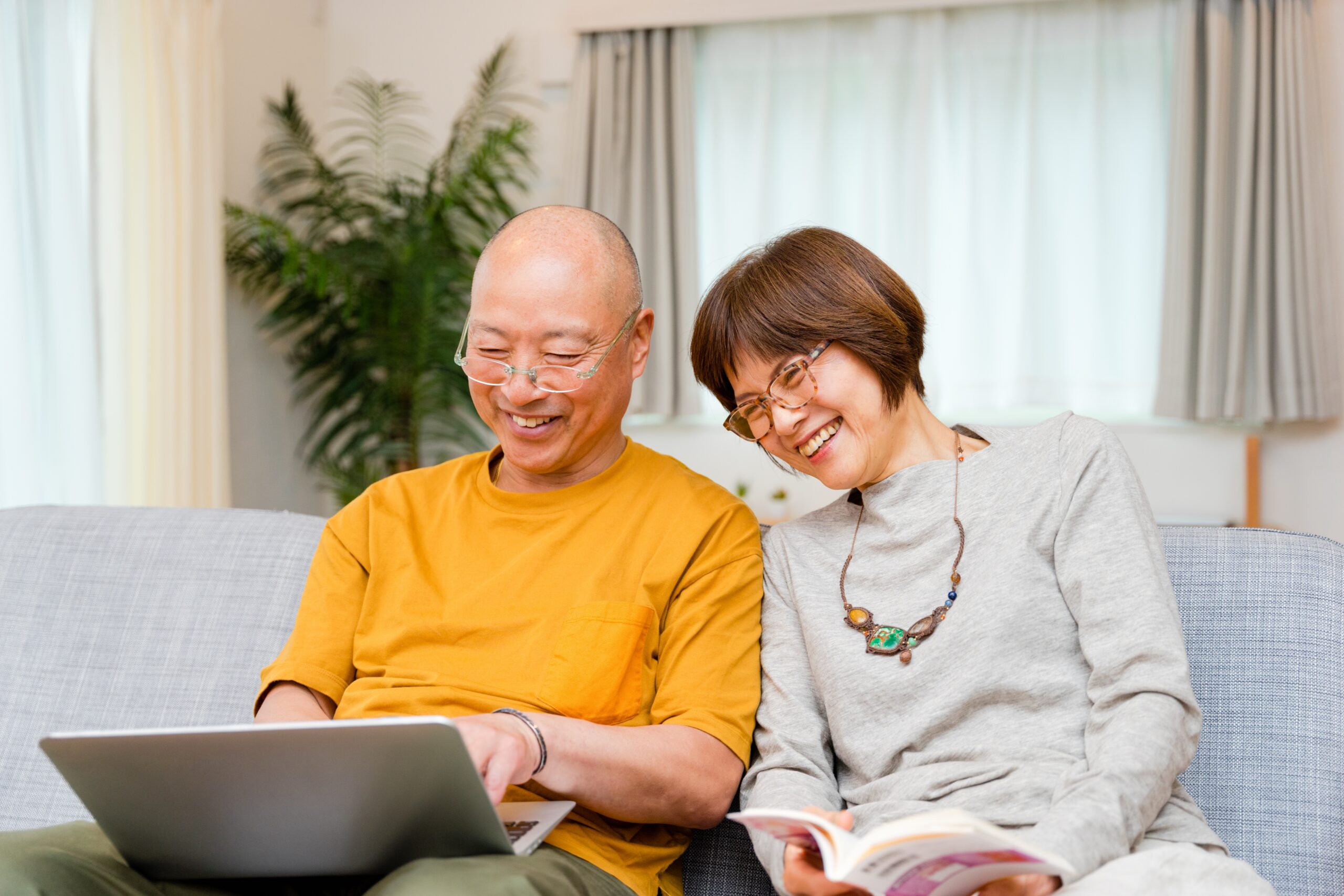 Couple look at laptop smiling