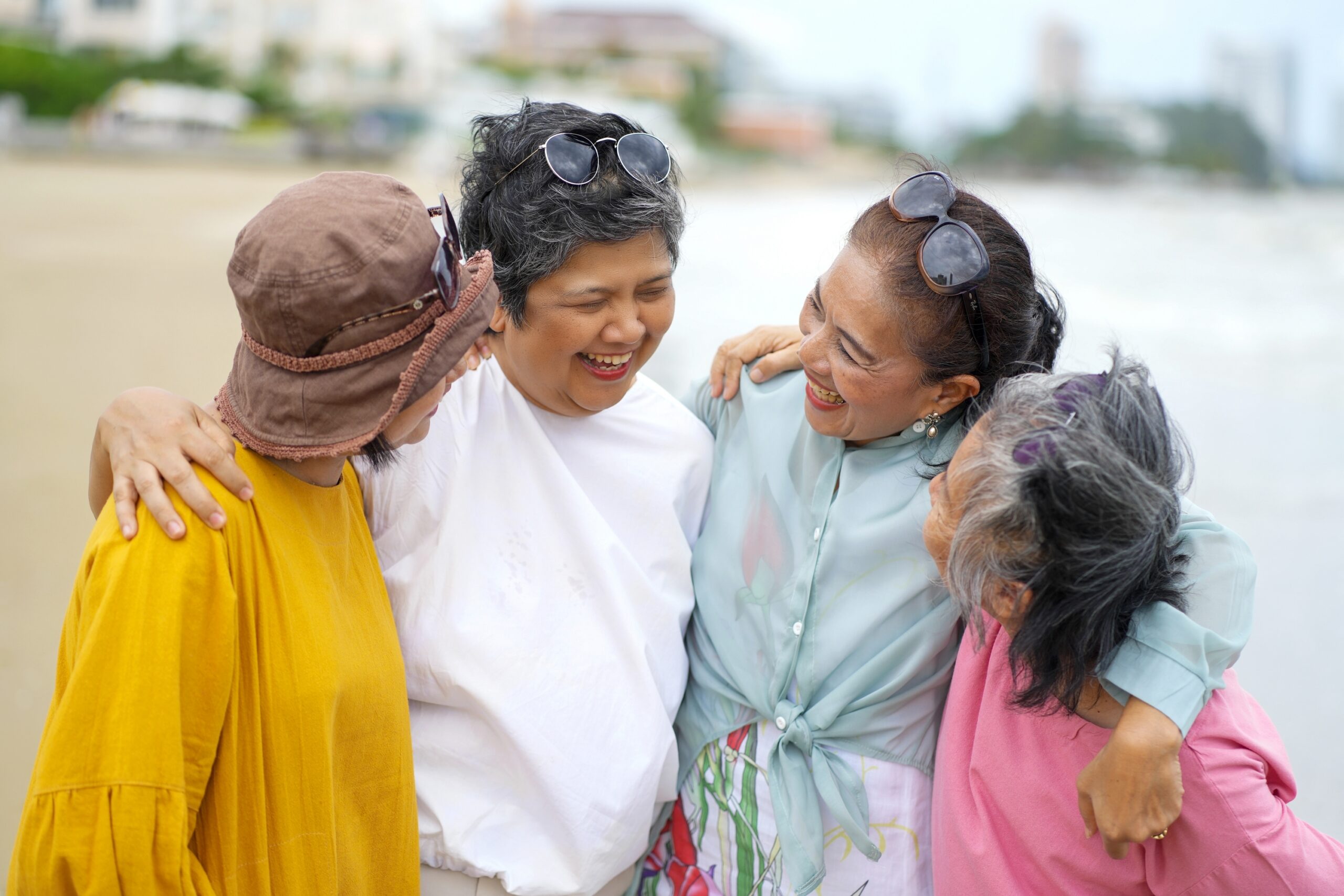 A group of women smiling at eachother.