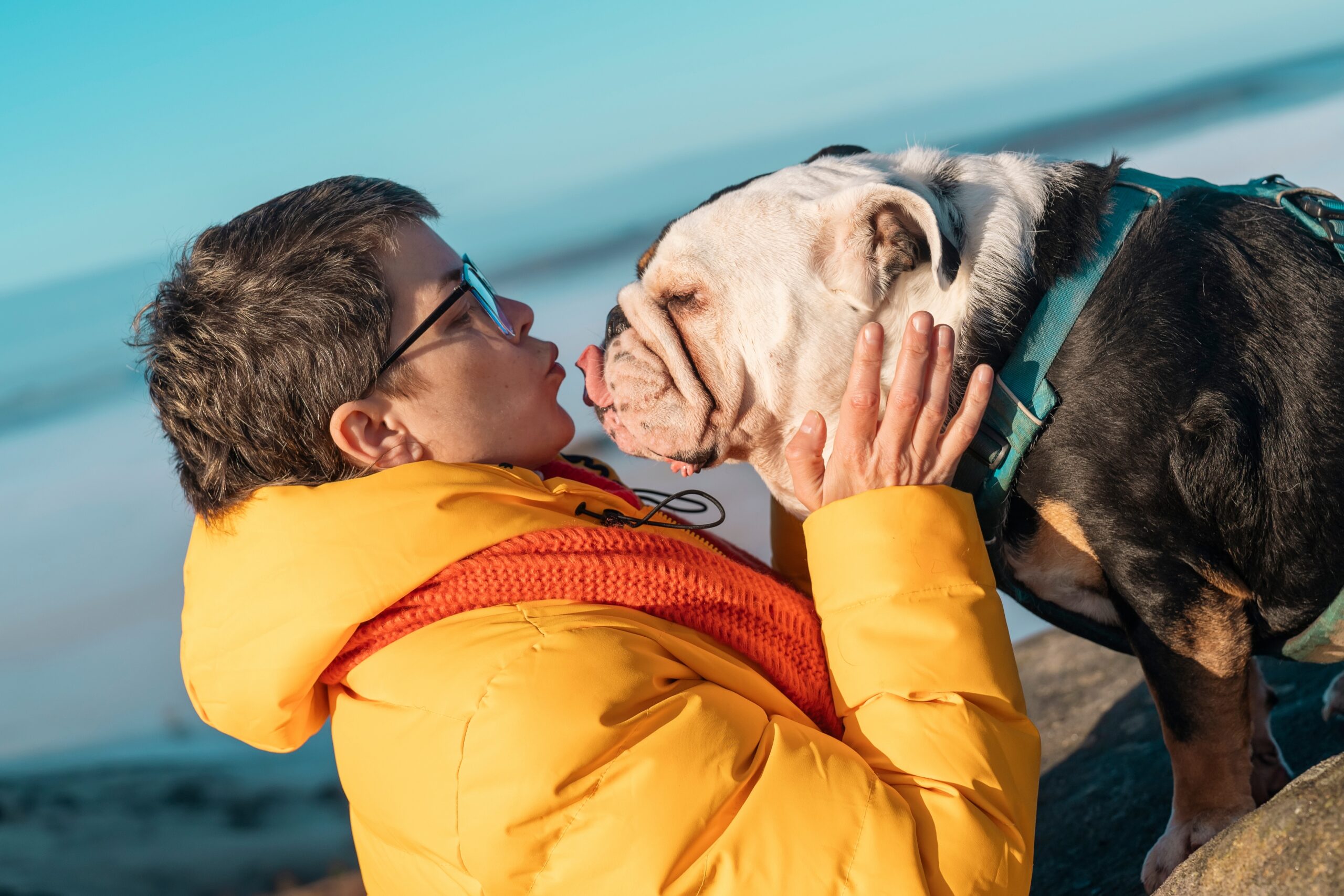 A person kissing their dog.