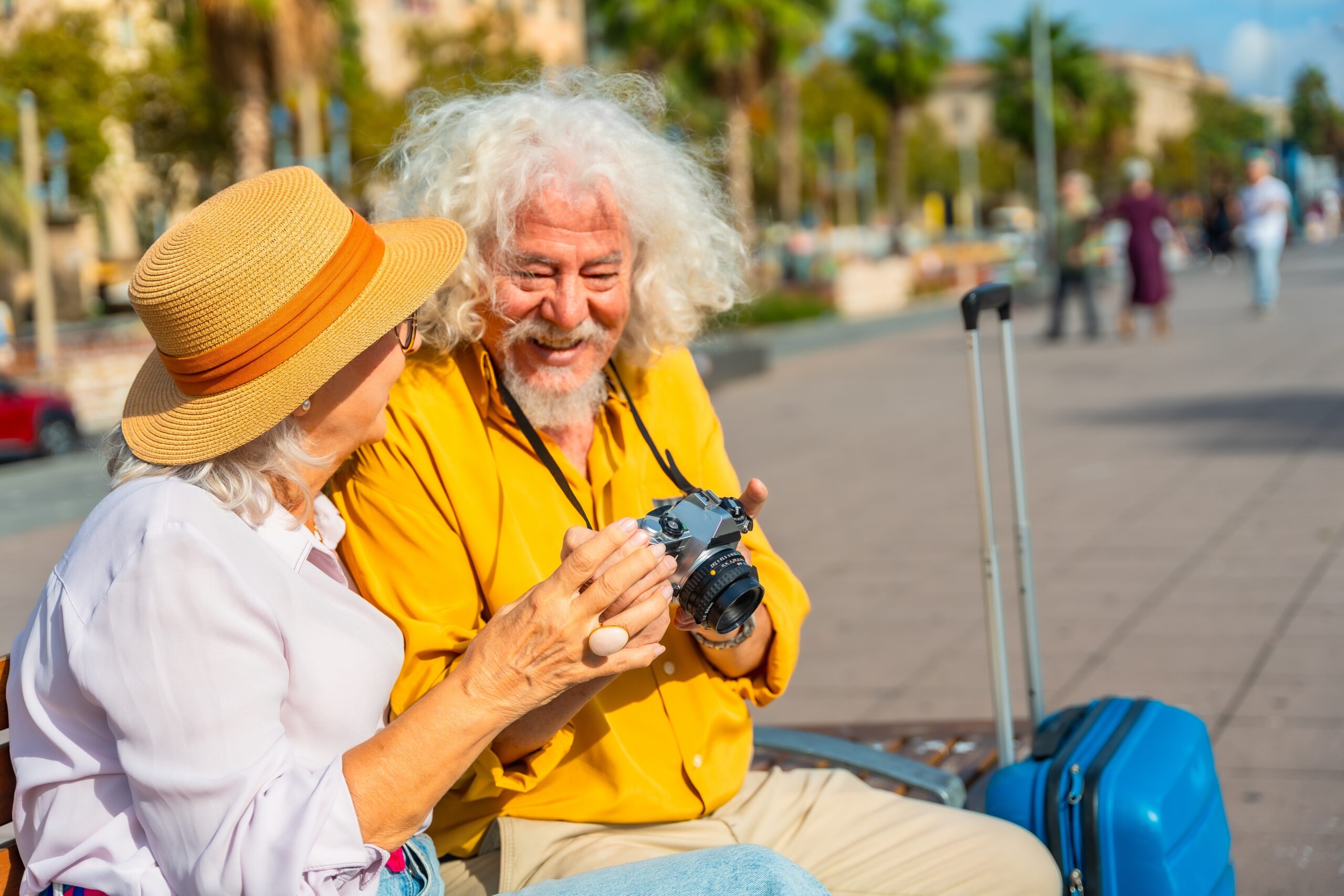 A man and a woman sat on a bench together.