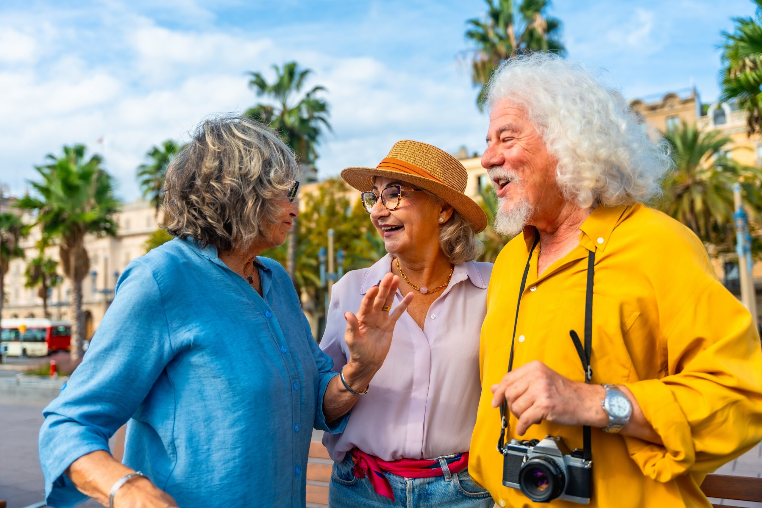 Three older people smiling together.